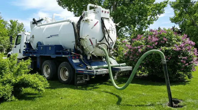 Professional vacuum truck performing residential drainage and septic maintenance in Arvada, CO