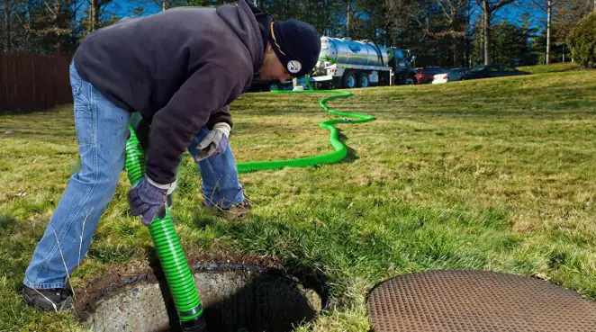 Service technician performing residential septic pumping and drainage maintenance in Arvada, CO